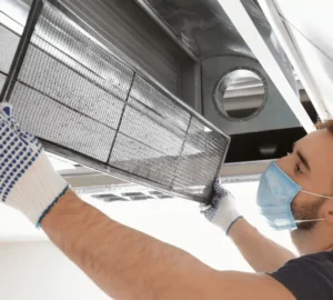 a technician is inspecting the panels of ac for service