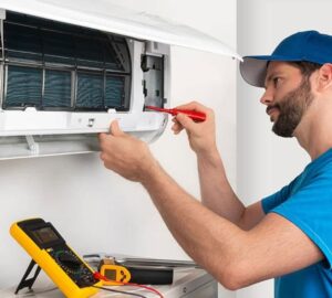 A technician performs a Repair Fan & Thermostat service in dubai on a split AC unit, addressing Fan & Thermostat Issues